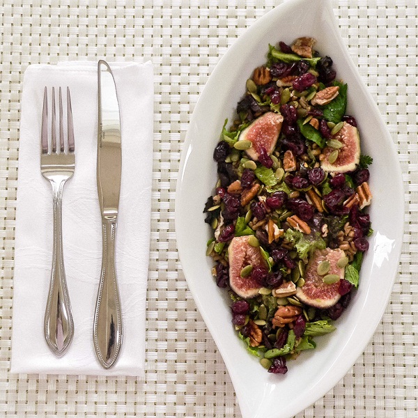 Top view of Mixed Green Farro Salad and Fresh Figs in a salad bowl
