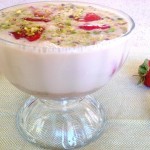 a front view of amaranth soup with roasted strawberries