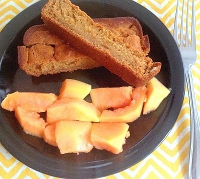 papaya oatmeal bread sticks with a side of fresh papaya on the serving plate