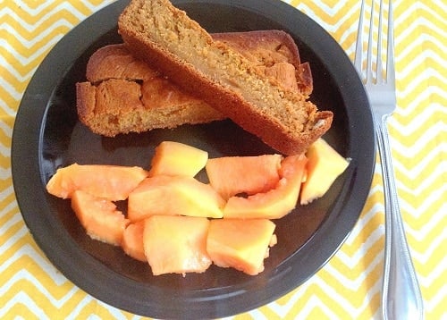 papaya oatmeal bread sticks with a side of fresh papaya on the serving plate