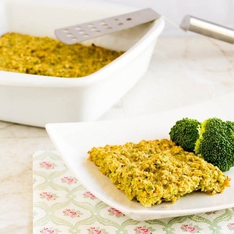 A plate with broccoli oatmeal slice with the baking pan at the backdrop