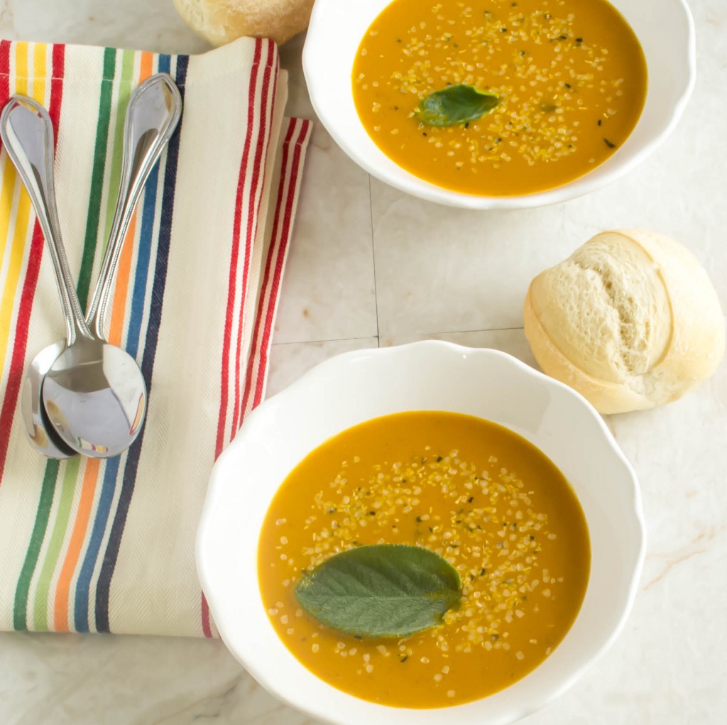 Top view of Spicy Carrot Amaranth Soup in white soup bowls and garnished