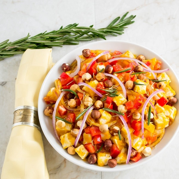 Butternut squash tofu salad with toasted hazelnuts in a serving bowl