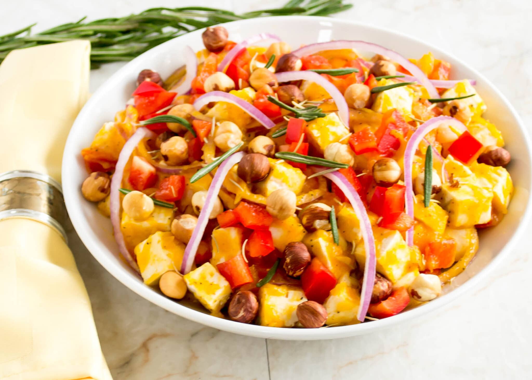 Close up view of butternut squash tofu salad with toasted hazelnuts