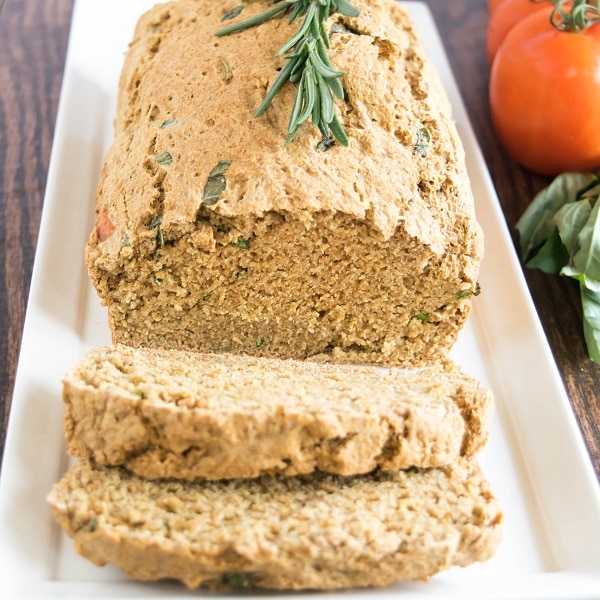 A front view of sliced tomato herbed spelt bread