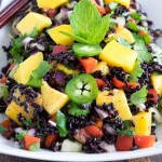 A 45 degree angle view of black rice mango salad