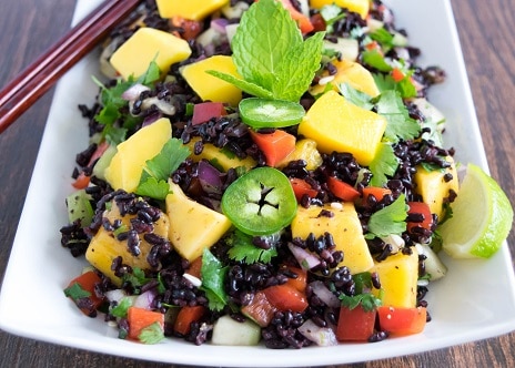 A 45 degree angle view of black rice mango salad