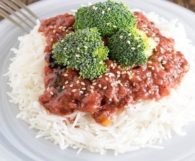 A 45 degree angle view of broccoli in strawberry sauce