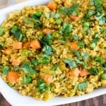 A top view of Masala Oatmeal in a serving dish with garnishes