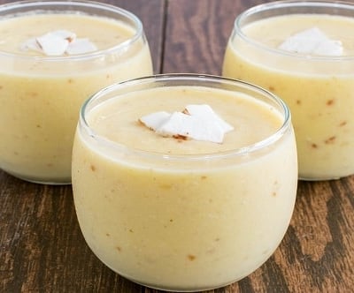 A front view of 3 glasses filled with Pineapple Coconut Tropical Smoothie