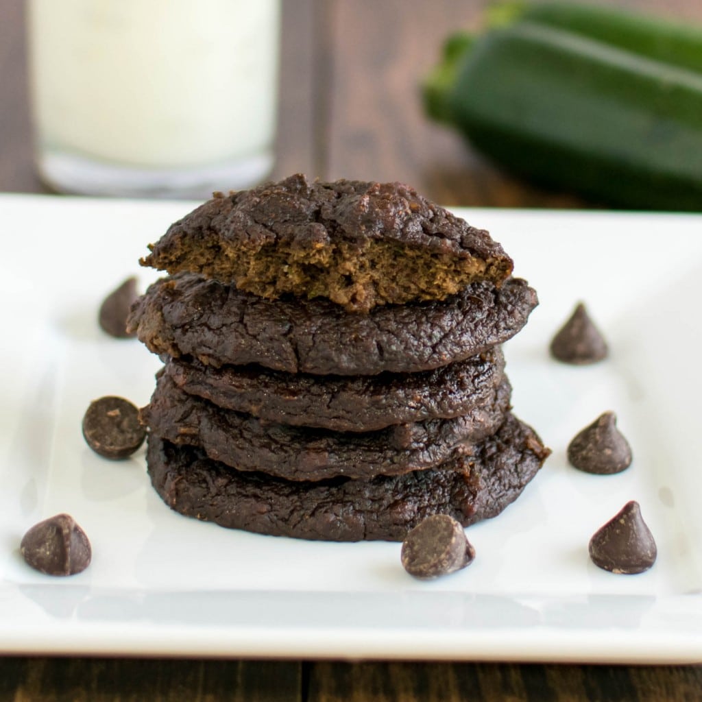A stack of Flourless Chocolate Zucchini Cookies with a half eaten cookie at the top.