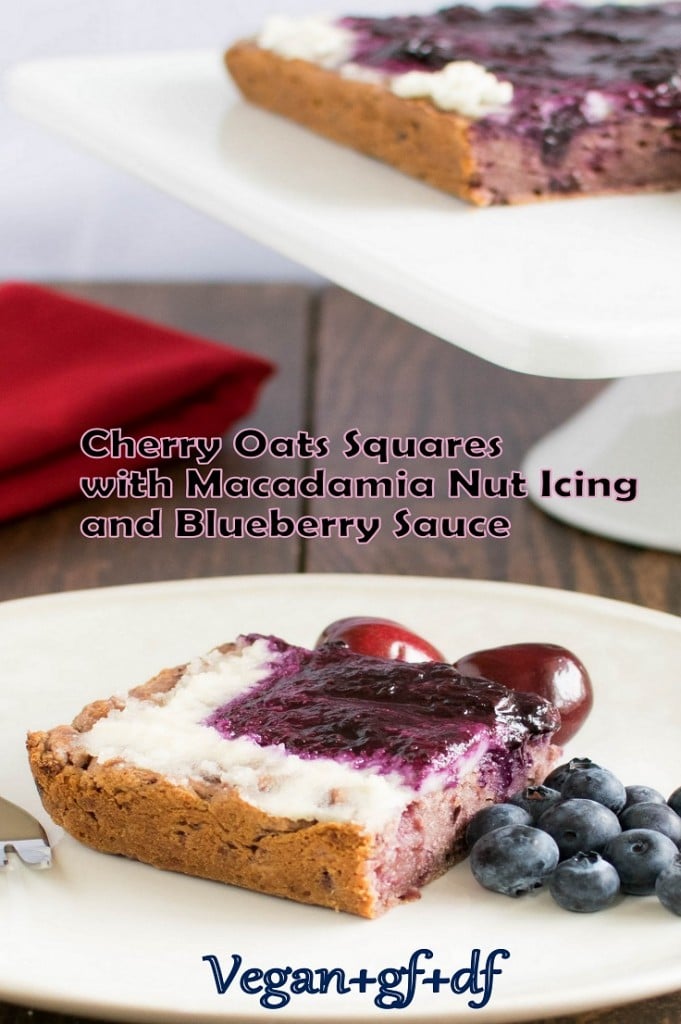 A full view of cherry oats squares with macadamia nut icing and blueberry sauce