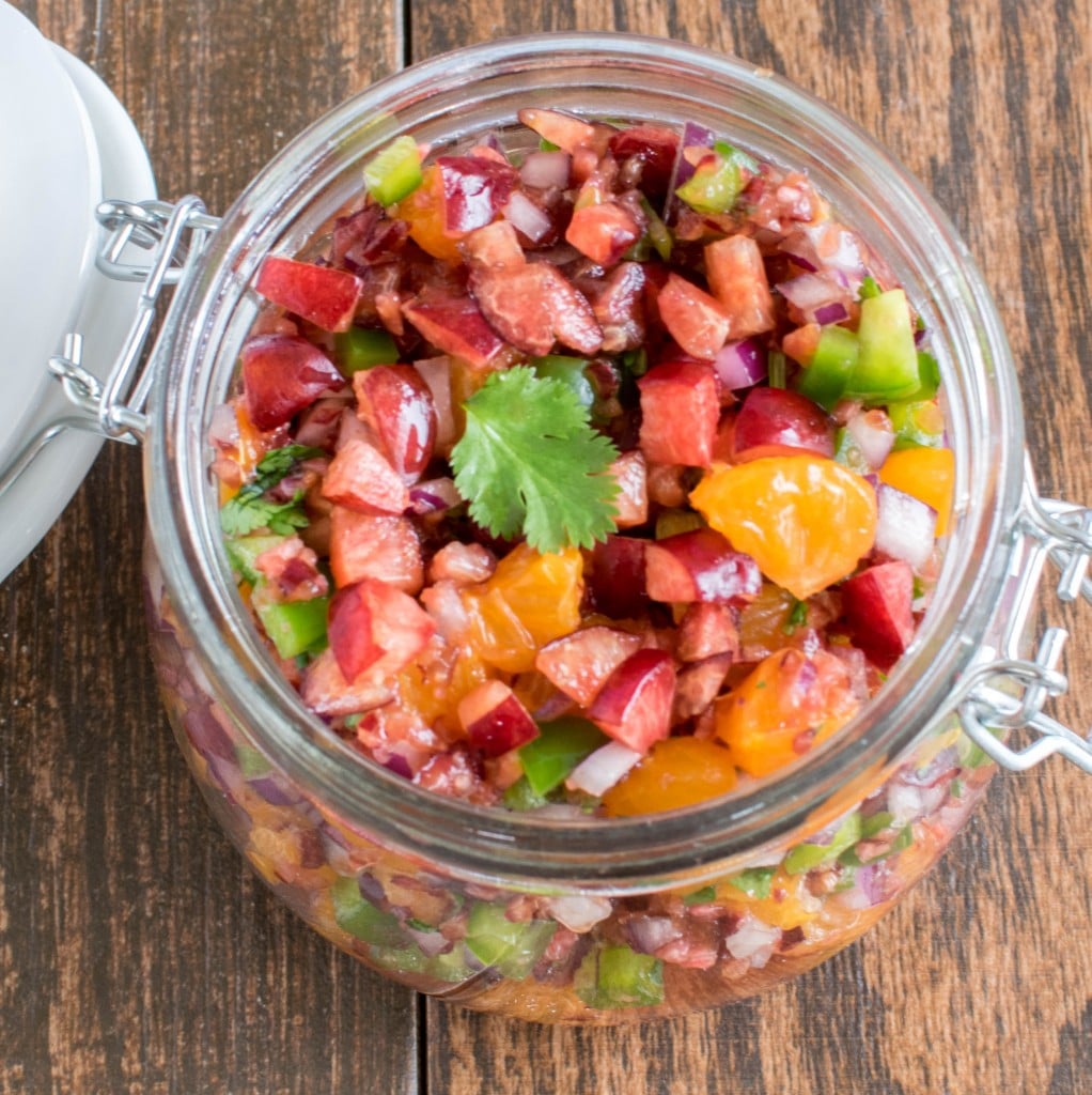 top view of cherry orange salsa in a jar