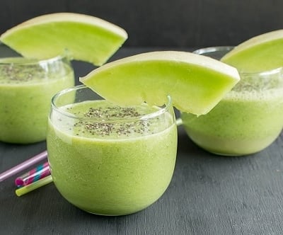 A front view of glasses filled with kale Honey Dew Melon Smoothie