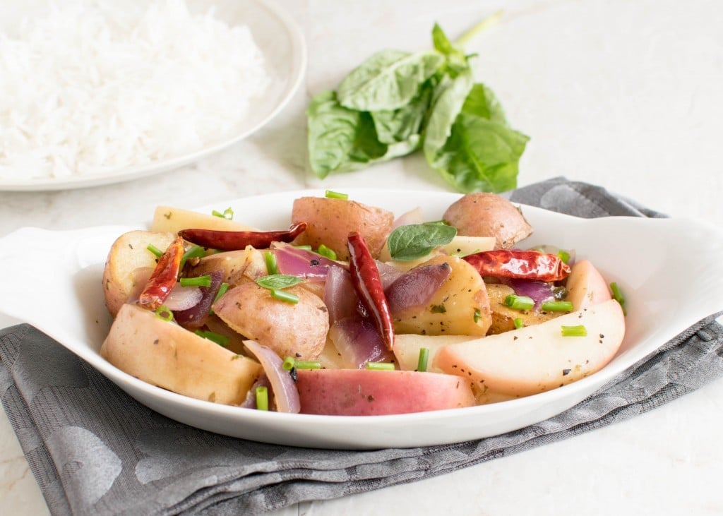 A front view of peaches and red potatoes stir fry