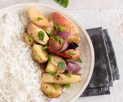 Top view of peaches and red potatoes stir fry