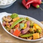 a front view of vegetables in chili garlic sauce served with rice.