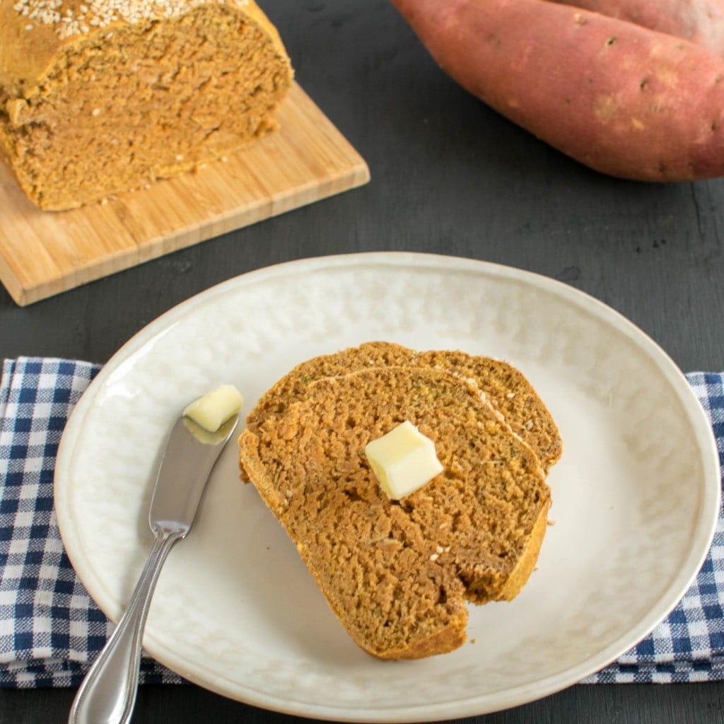 A slice of Bread topped with vegan butter on a serving plate 