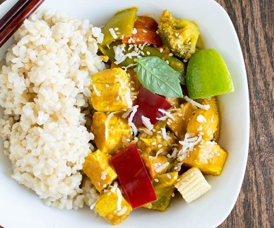A serving plate with Asian tofu curry and brown rice