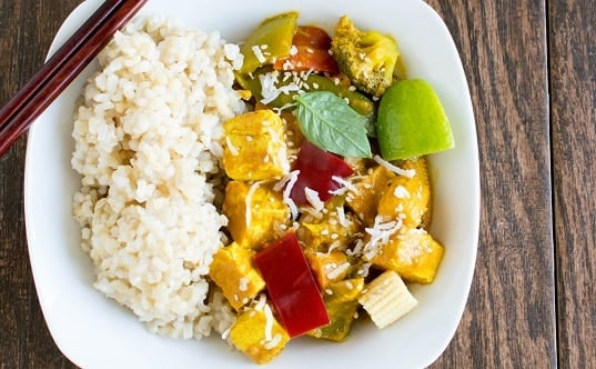 A serving plate with Asian tofu curry and brown rice