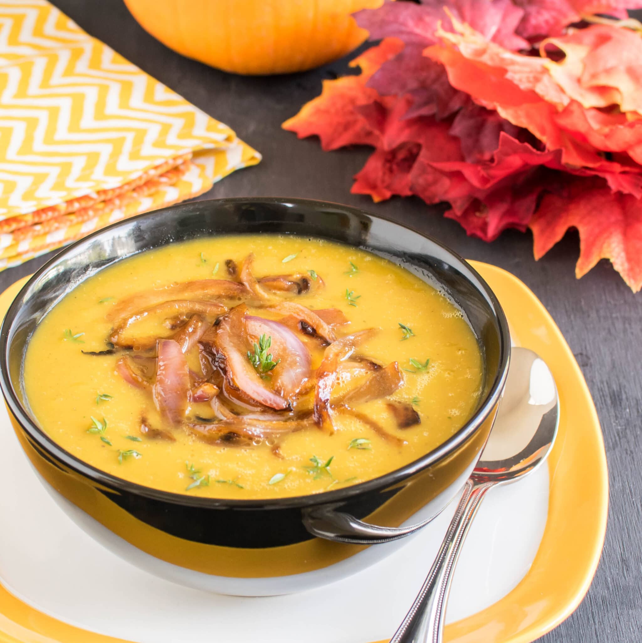 A 45 degree angle view of Apple Pumpkin Soup with Caramelized Onions