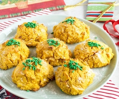 A serving plate filled with carrot sweet potato almond cookies topped with sprinkles