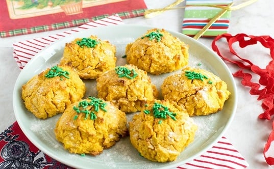 A serving plate filled with carrot sweet potato almond cookies topped with sprinkles