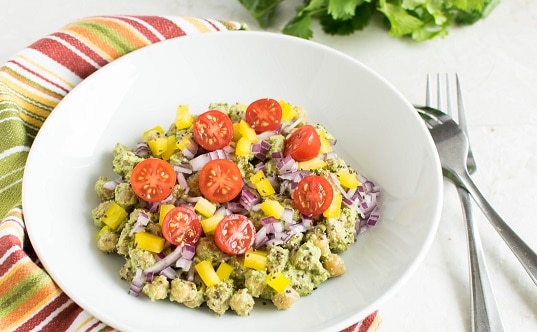 a close up view of chickpeas salad in cilantro dip