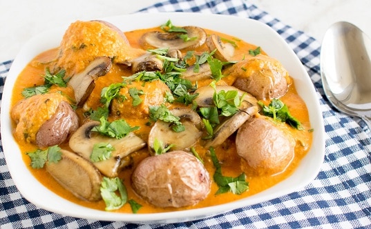 A front view of Red Potato Mushroom Curry in a serving bowl