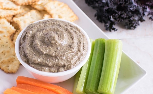 A close up view of cheesy purple kale dip
