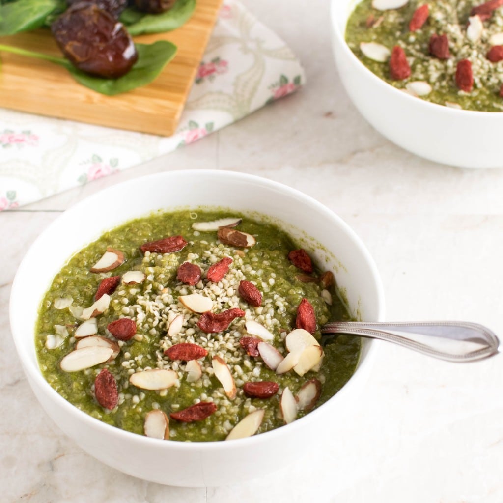  a spoon digging into spinach quinoa porridge