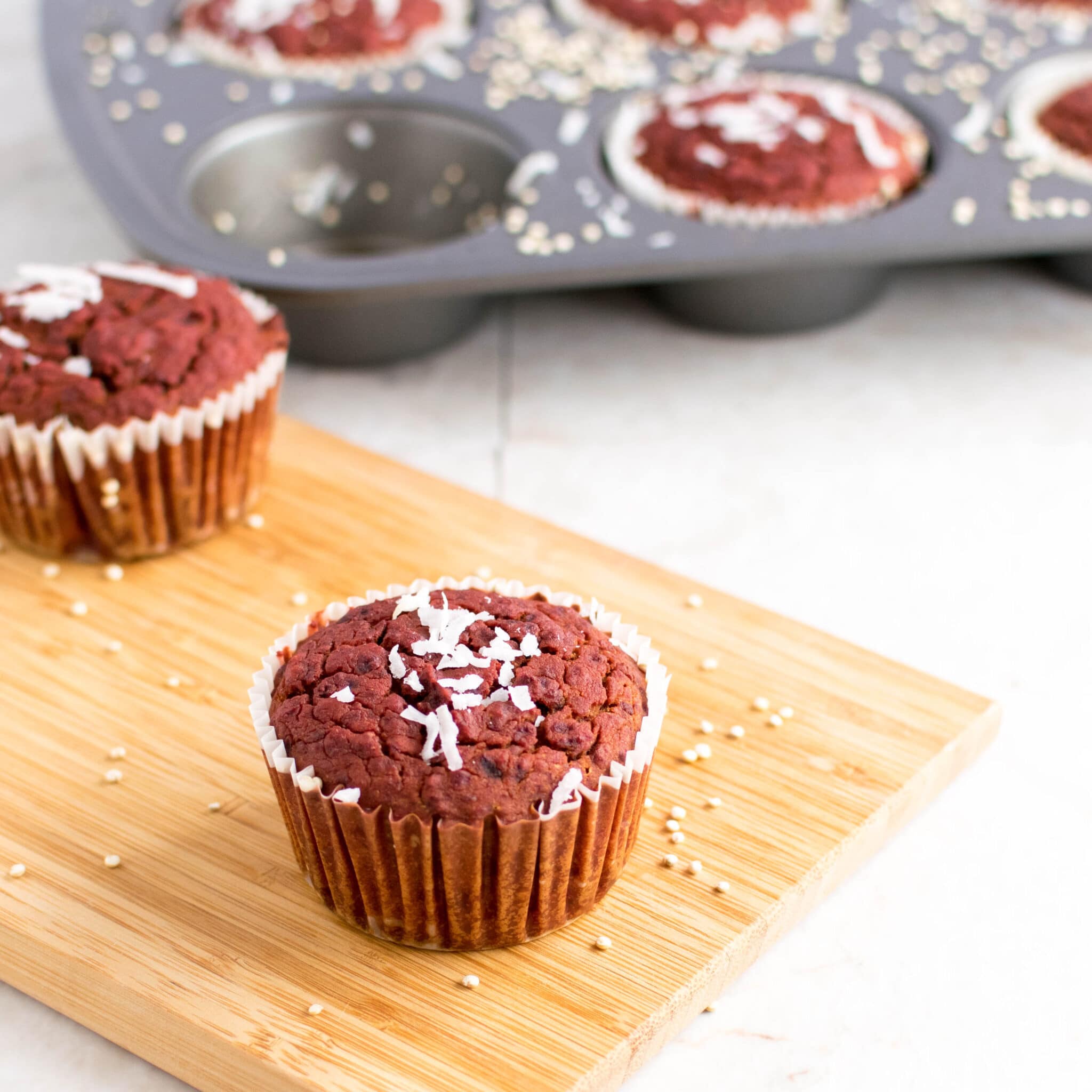 individual beetroot muffins on a wooden board. 