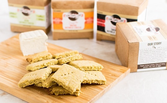 A wooden board filled with Vegan Cheese Turmeric Oats Crackers