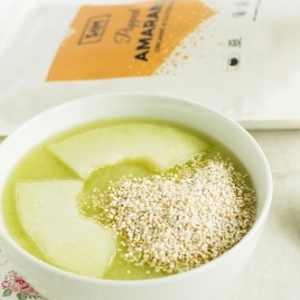 A close up view of popped amaranth honey dew cucumber smoothie bowl