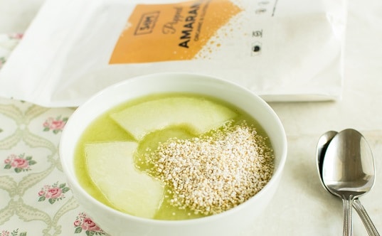 A close up view of popped amaranth honey dew cucumber smoothie bowl