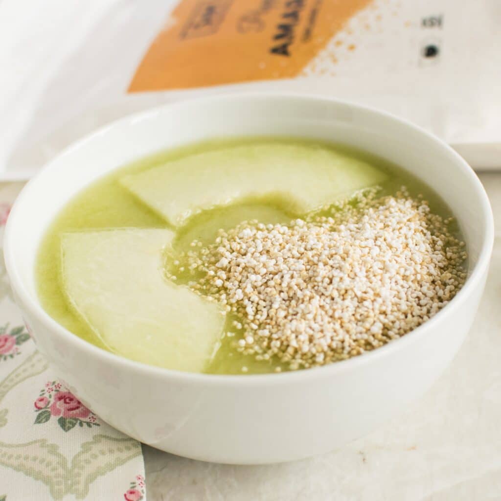 A close up view of popped amaranth honey dew cucumber smoothie bowl