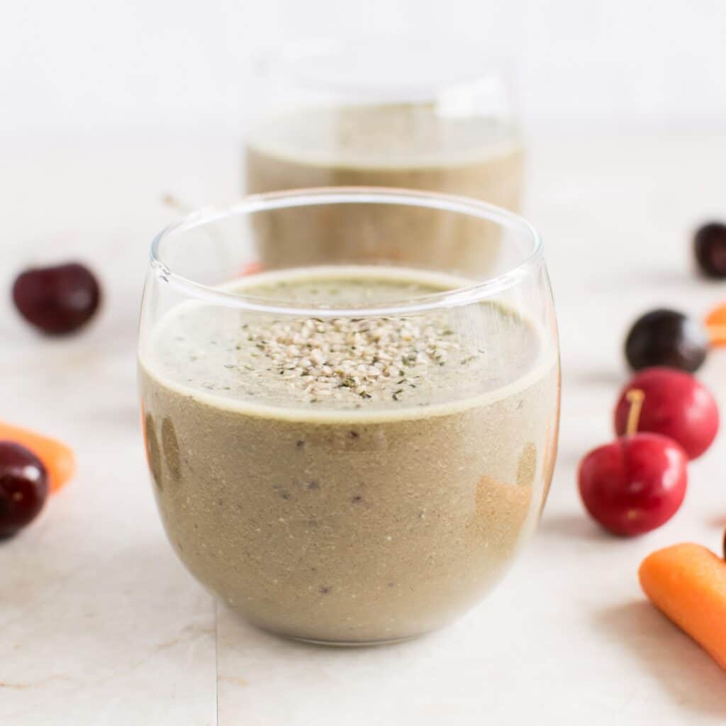 A front view of Cherry Carrot Smoothie in the serving glass is shown