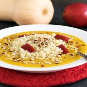 A front view of red pear butternut squash soup with quinoa
