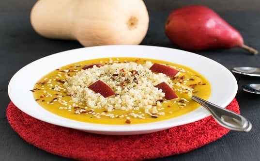A front view of red pear butternut squash soup with quinoa