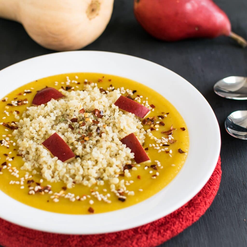 A close up view of red pear butternut squash soup with quinoa