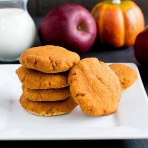 A stack of Apple Sauce Pumpkin Cookies with the ingredients as the props