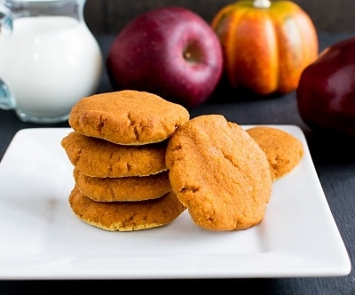 A stack of Apple Sauce Pumpkin Cookies with the ingredients as the props