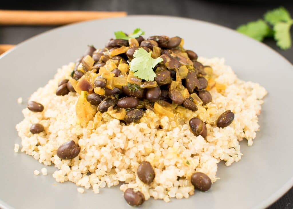 30 degree angle view of served black beans curry. 