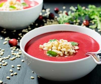 A front view of cranberry barley soup in serving bowls.