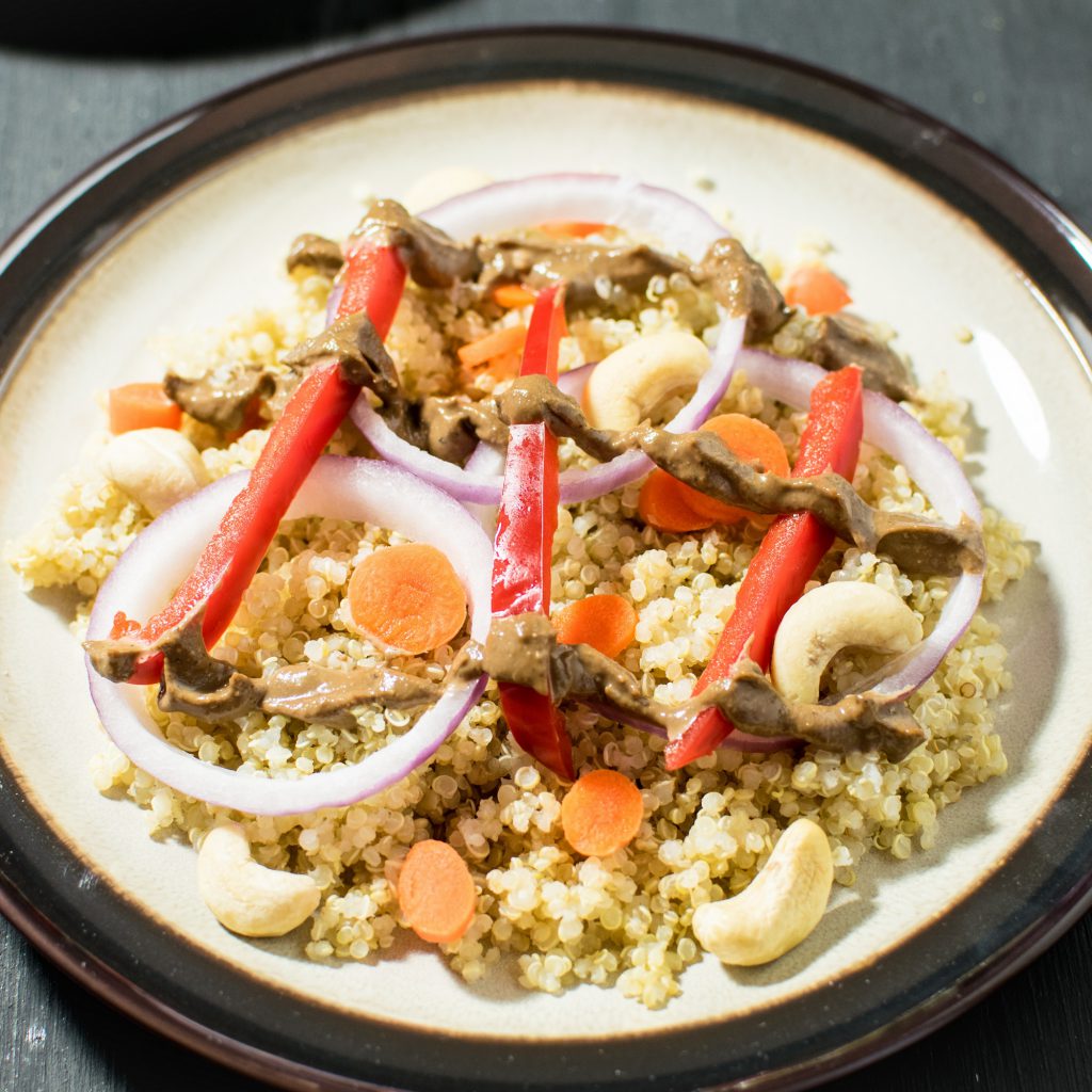 a close up view of cashew balsamic quinoa salad