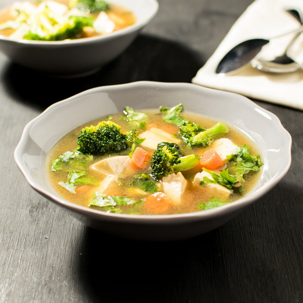 Front view of of two bowls with cilantro tofu soup