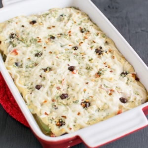 Baked Black Beans in Vegan Cheese Sauce is shown in a baking dish