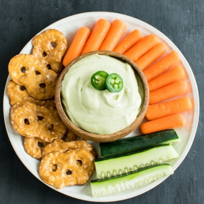Top view of Fire Roasted Jalapeno Dip with the sides of veggies and pretzels