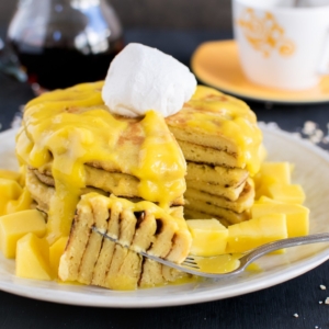 Sliced mango cream cheese vegan pancakes with mango puree
