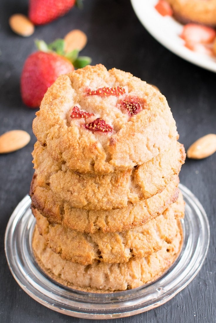 A stack of Strawberry Yogurt Vegan Cookies with fresh strawberries as the prop